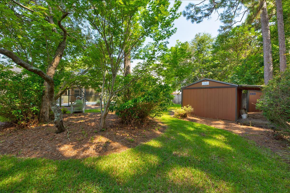 1818 Huntington Road Niceville, FL 32578 - Photo 48 of 53 a backyard of a house with table and chairs