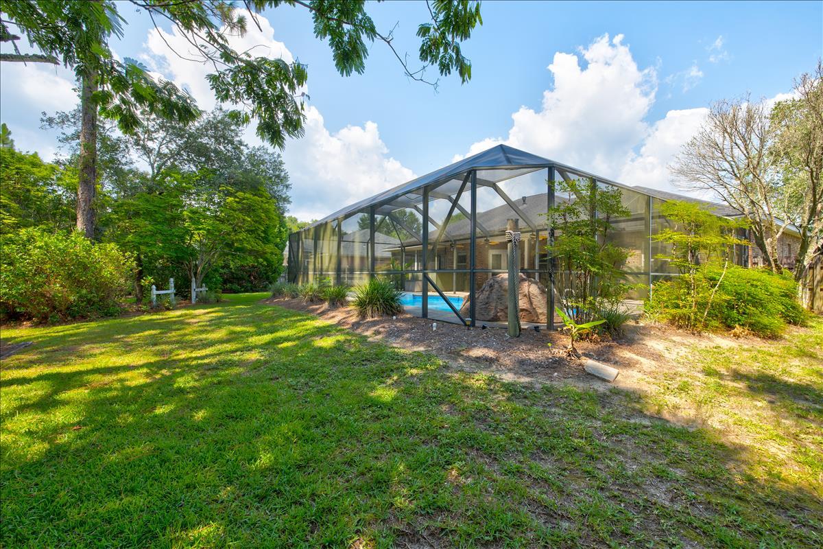 1818 Huntington Road Niceville, FL 32578 - Photo 52 of 53 a view of a house with backyard and a patio
