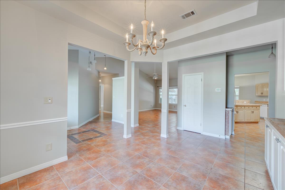1818 Huntington Road Niceville, FL 32578 - Photo 7 of 53 a view of a hallway with a chandelier and dining table