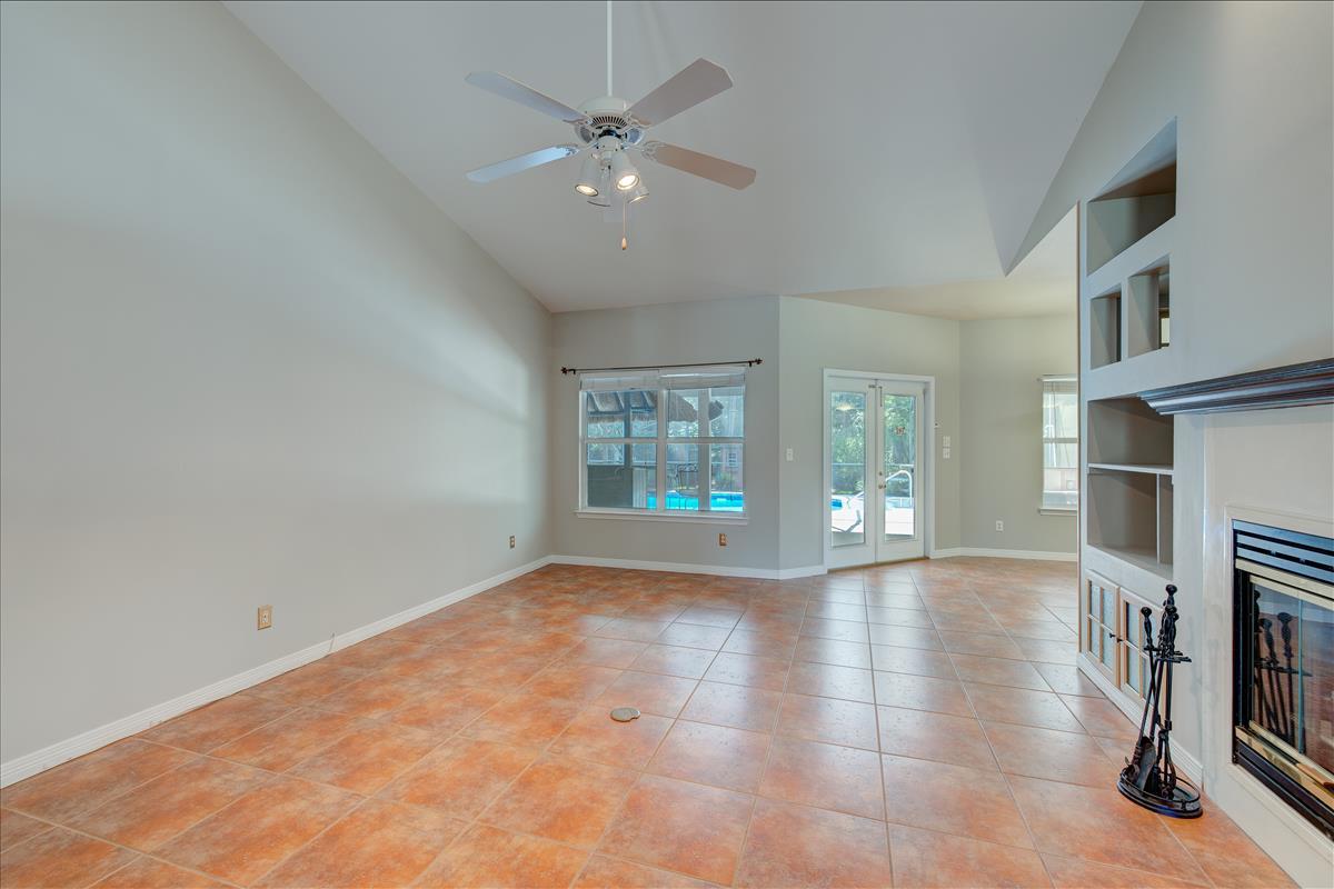 1818 Huntington Road Niceville, FL 32578 - Photo 8 of 53 a view of an empty room with fireplace and a window
