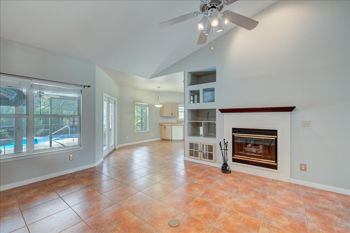 1818 Huntington Road Niceville, FL 32578 - Photo 9 of 53 a view of an empty room with a fireplace and a window