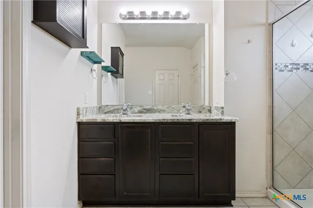 a bathroom with a sink vanity and mirror