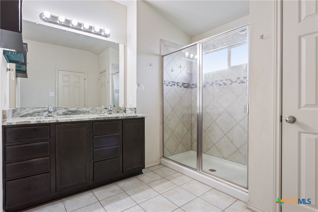 231 Druse Lane Jarrell, TX 76537 - Photo 17 of 38 a bathroom with a shower sink and mirror