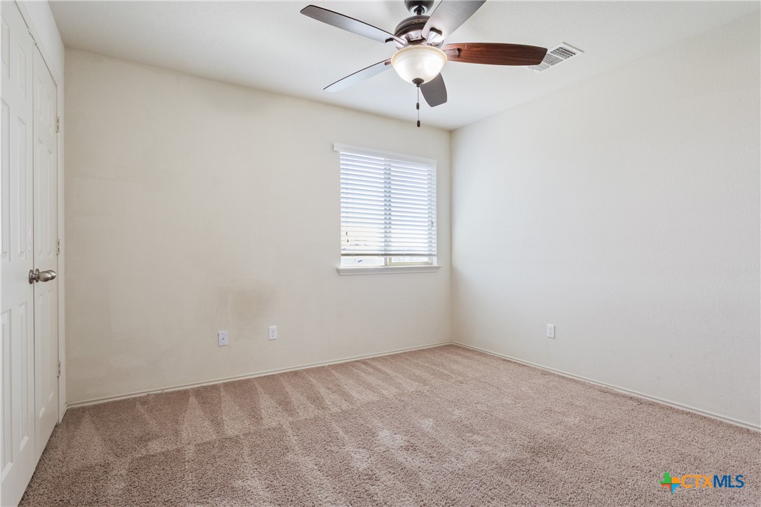 231 Druse Lane Jarrell, TX 76537 - Photo 23 of 38 an empty room with a window and a fan