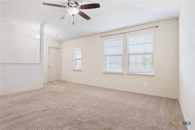 a view of an empty room with a window