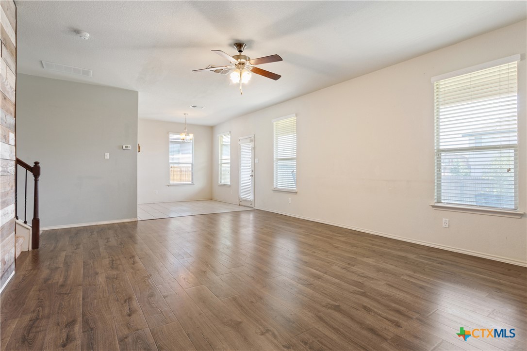 231 Druse Lane Jarrell, TX 76537 - Photo 5 of 38 a view of an empty room with wooden floor and a window