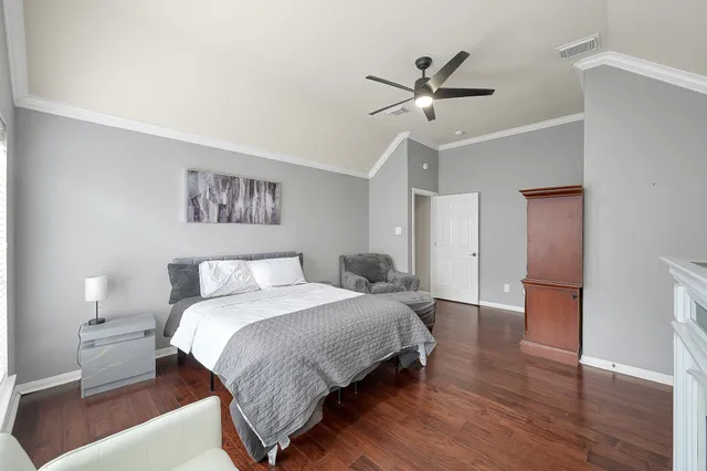a bedroom with a bed and a ceiling fan