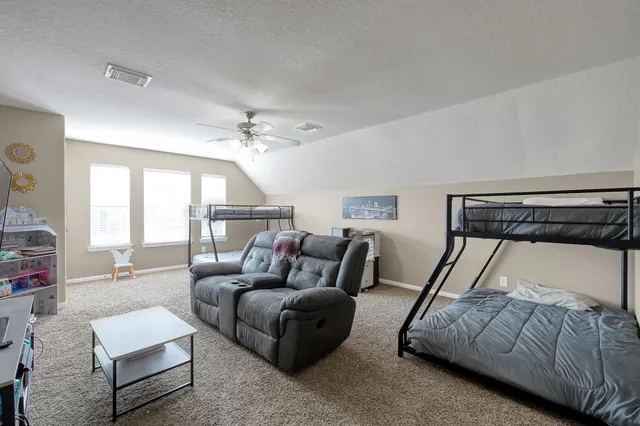 a bedroom with furniture and a mirror