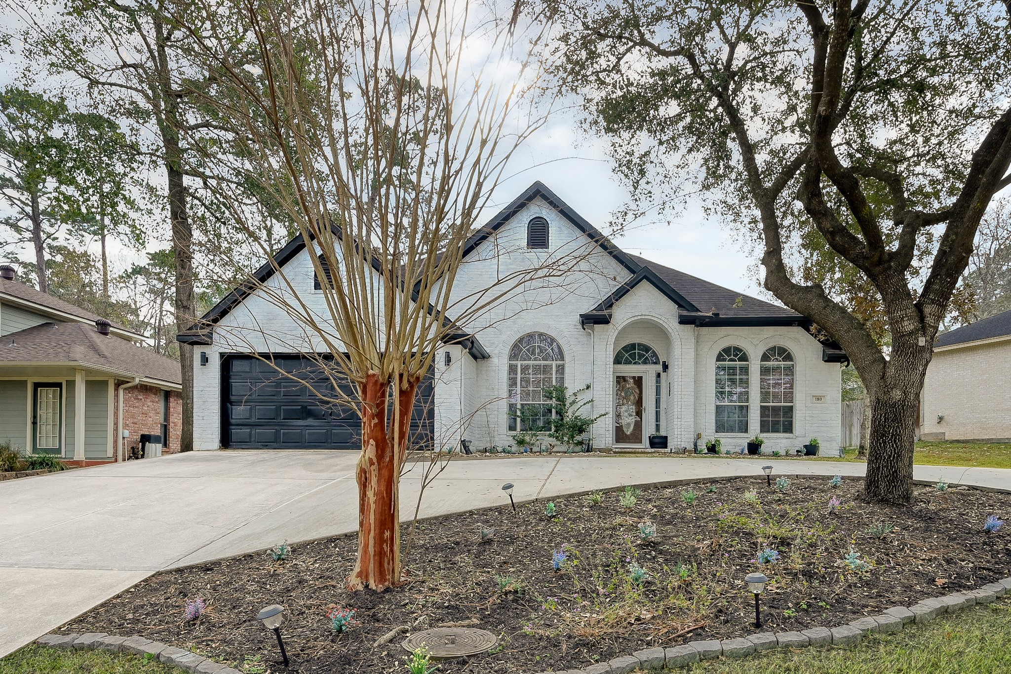 180 Park Way Conroe, TX 77356 - Photo 2 of 23 a front view of a house with a yard and large trees
