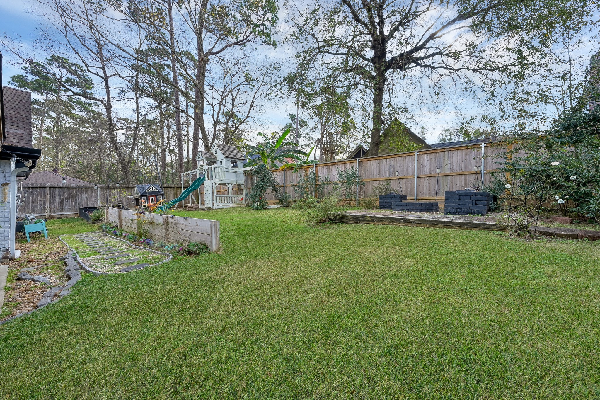 180 Park Way Conroe, TX 77356 - Photo 21 of 23 a view of a backyard with a garden and trees