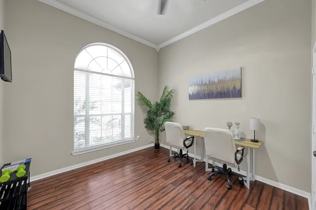 a view of a room with a window and wooden floor