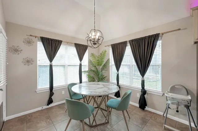 a view of a dining room with furniture window and outside view