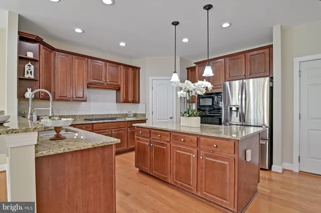a dining room with furniture a chandelier and wooden floor