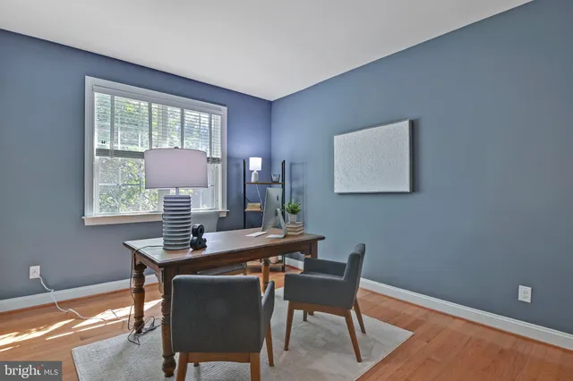 a bathroom with a sink a large mirror and a light fixture