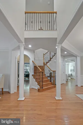 a view of a dining room with furniture a chandelier and wooden floor