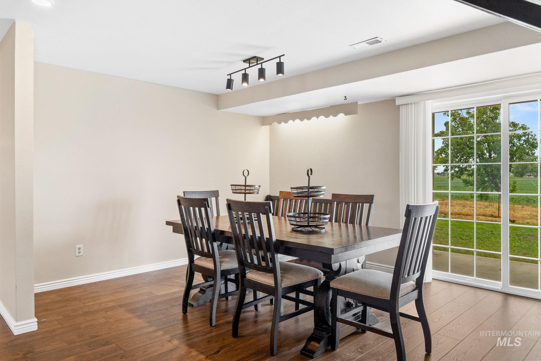 18338 Pride Lane Caldwell, ID 83607 - Photo 8 of 50 Dining area featuring wood-finish flooring, light-toned wall paint, and recessed lighting
