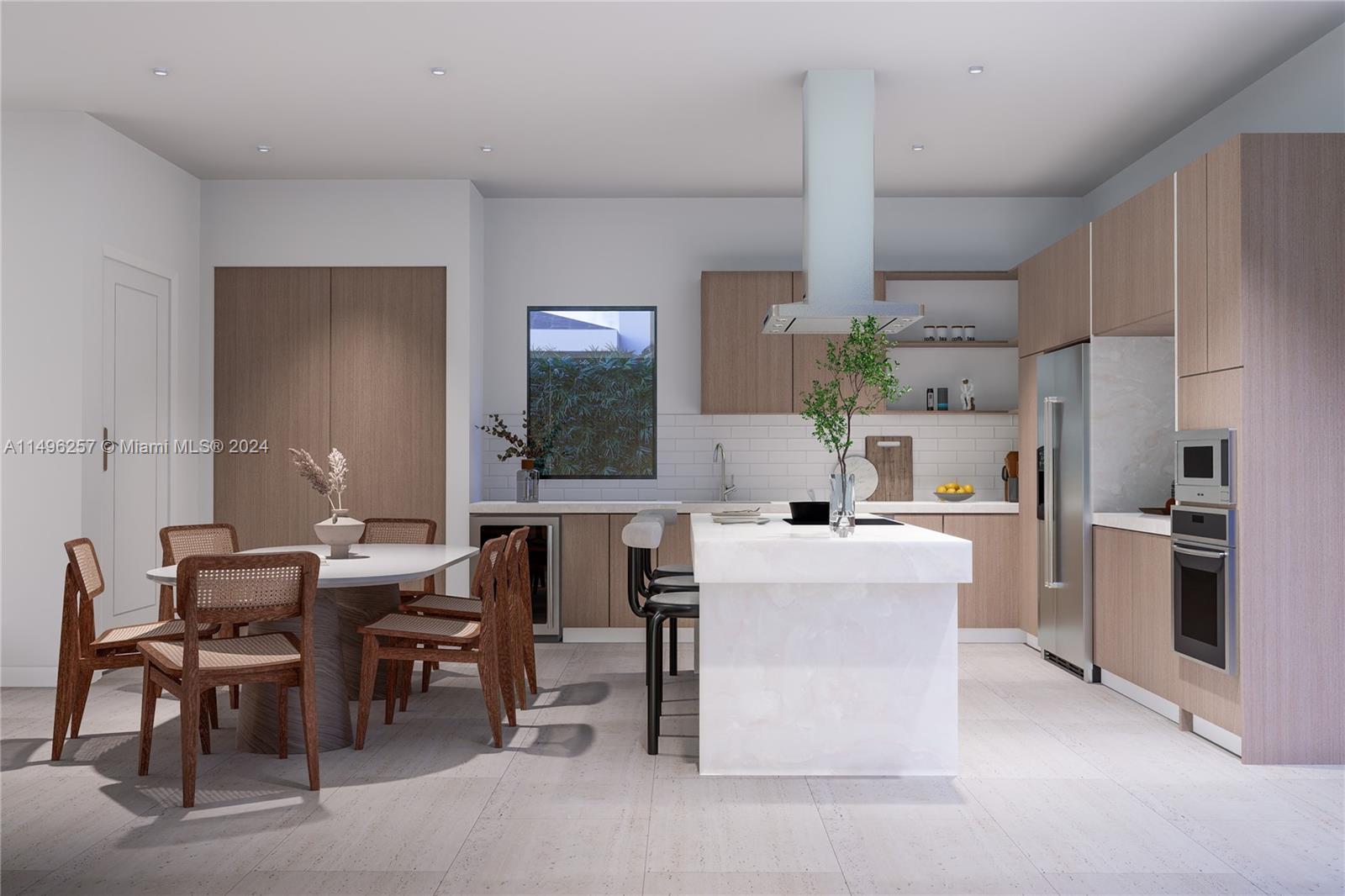 311 Southwest 21st Road Miami, FL 33129 - Photo 2 of 11 a kitchen with kitchen island a table and chairs in it