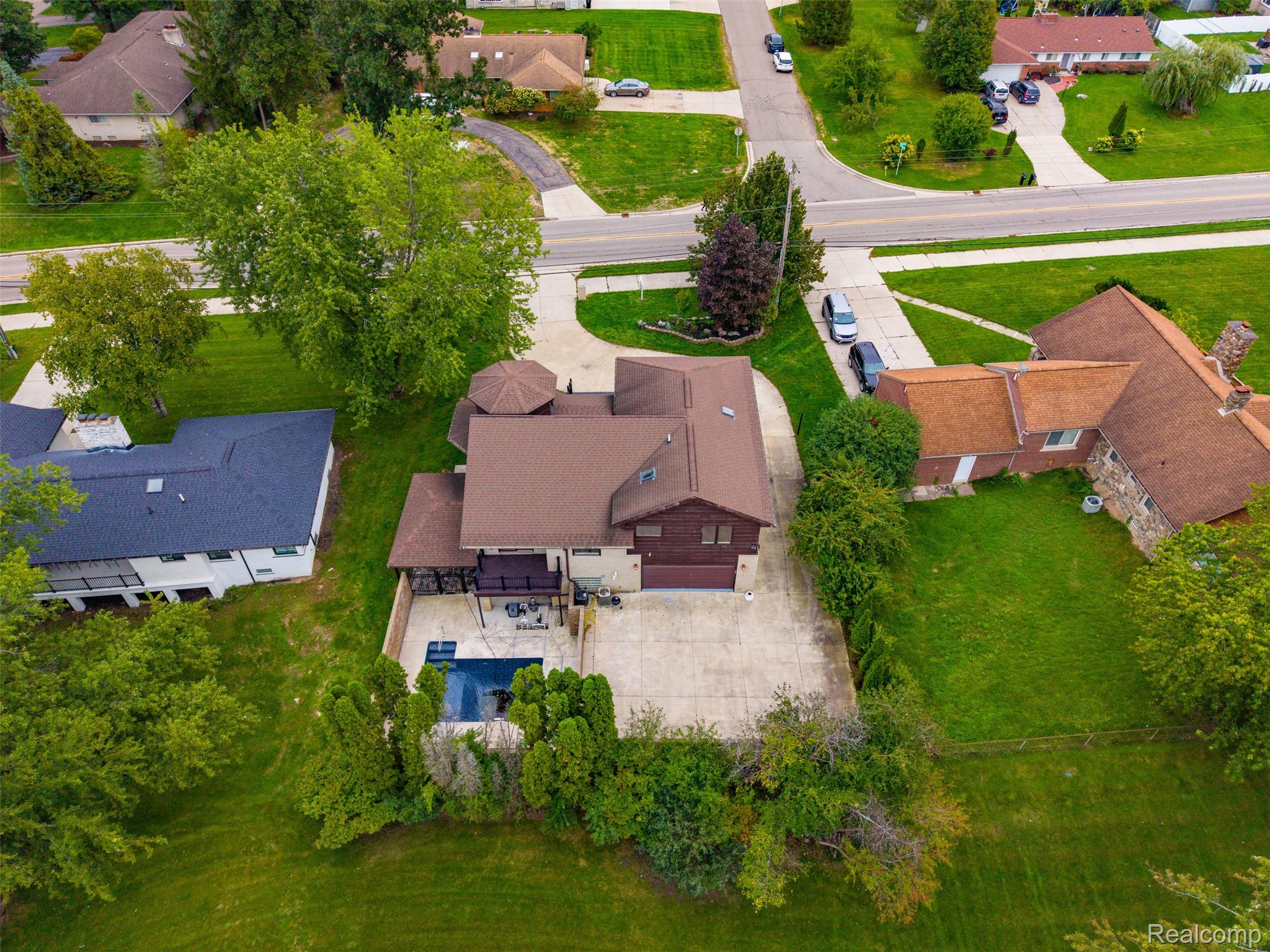 27507 Bell Road Southfield, MI 48034 - Photo 68 of 81 Property featuring a multi-level design, attached garage, private pool, and extensive paved patio space