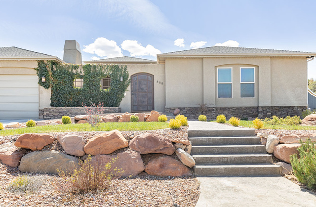 888 East Fiddlers Canyon Road Cedar City, UT 84721 - Photo 5 of 74 View of front of home featuring stucco siding, an attached garage, a chimney, and stone siding