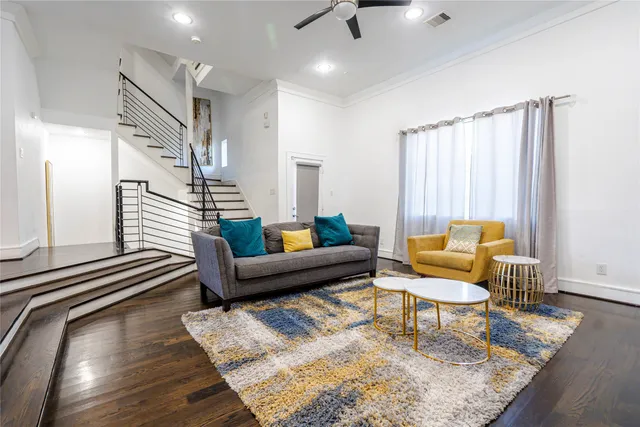 a living room with furniture and a wooden floor