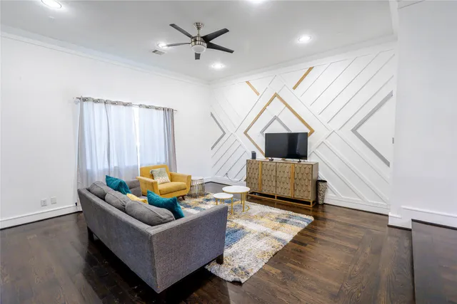 a living room with furniture and wooden floor