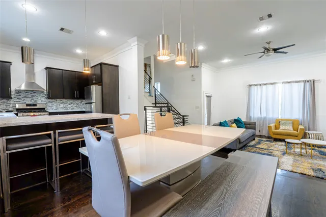 a kitchen with stainless steel appliances kitchen island granite countertop a sink a stove and a refrigerator