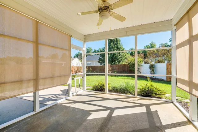 a view of backyard with tub and floor to ceiling window