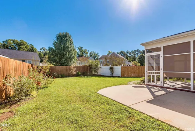 a backyard of a house with yard and outdoor seating