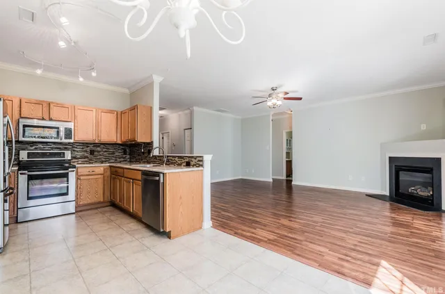 a kitchen with granite countertop a stove cabinets and a fireplace