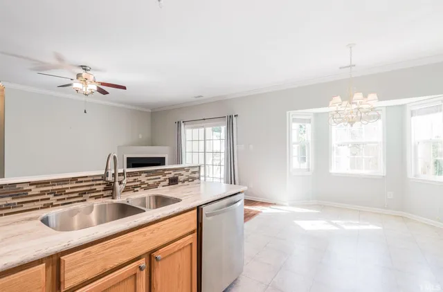 a kitchen with a sink a stove a microwave and cabinets