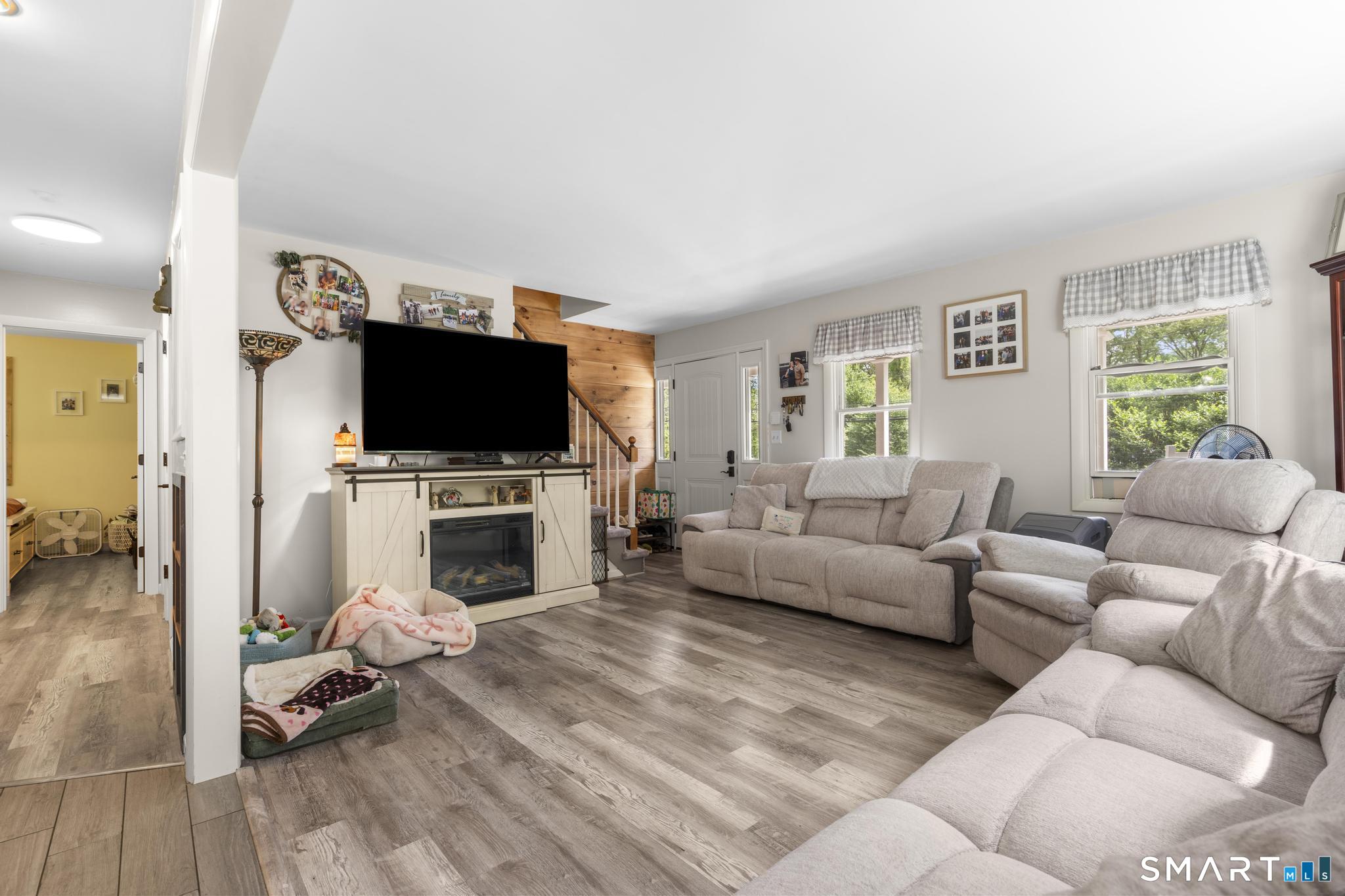 13 Christy Hill Road Ledyard, CT 06335 - Photo 8 of 38 a living room with furniture a fireplace and a flat screen tv
