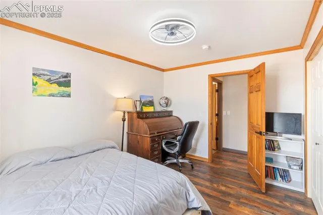 a bedroom with a bed and a chair in it