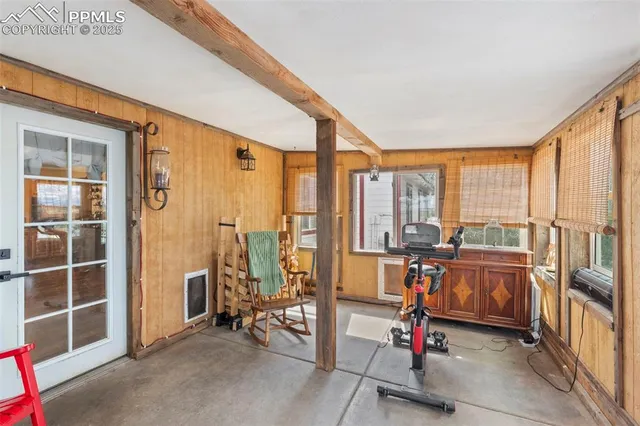 a view of an empty room with large windows