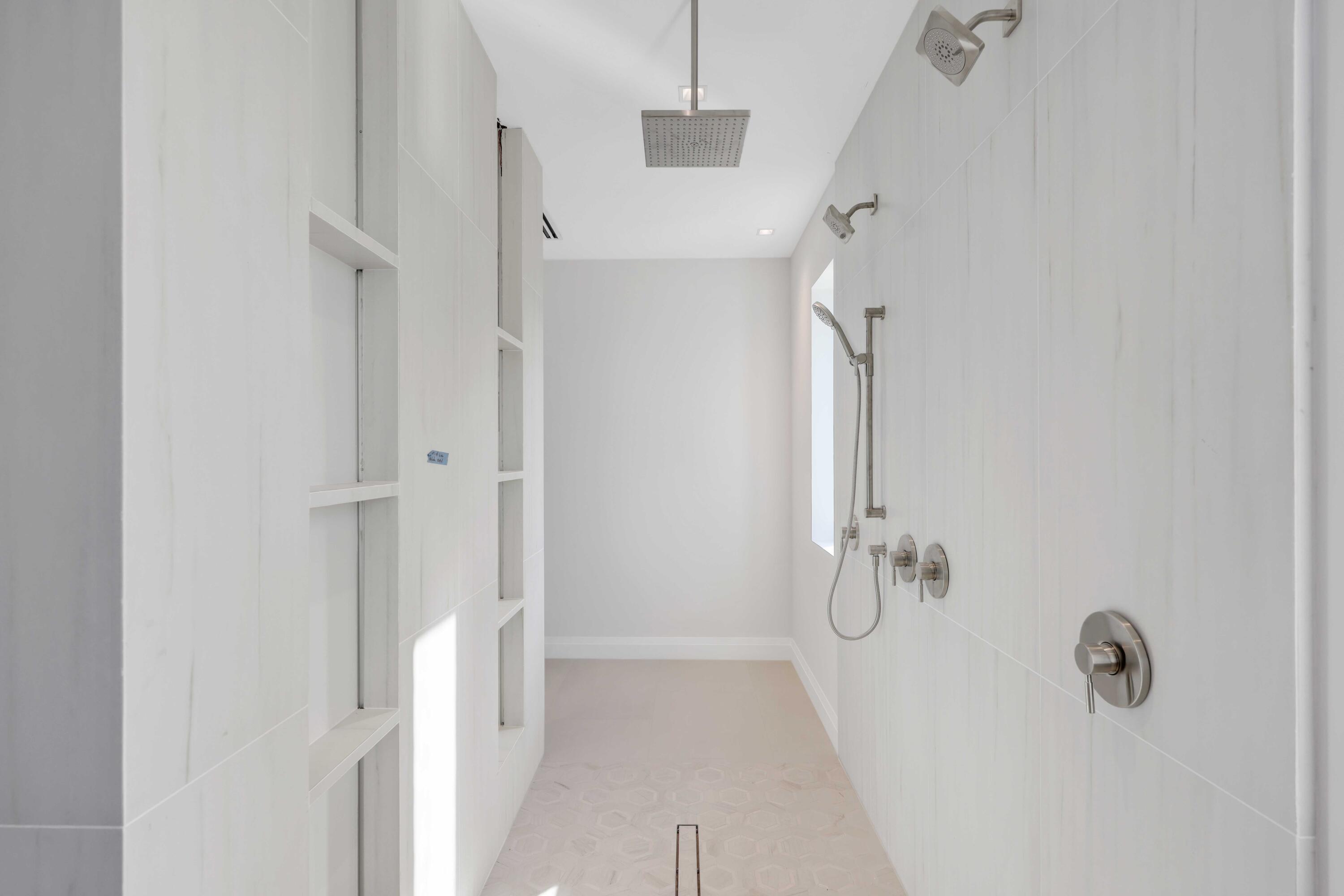 810 Northeast 70th Street Boca Raton, FL 33487 - Photo 24 of 32 a bathroom with a granite countertop shower and a sink