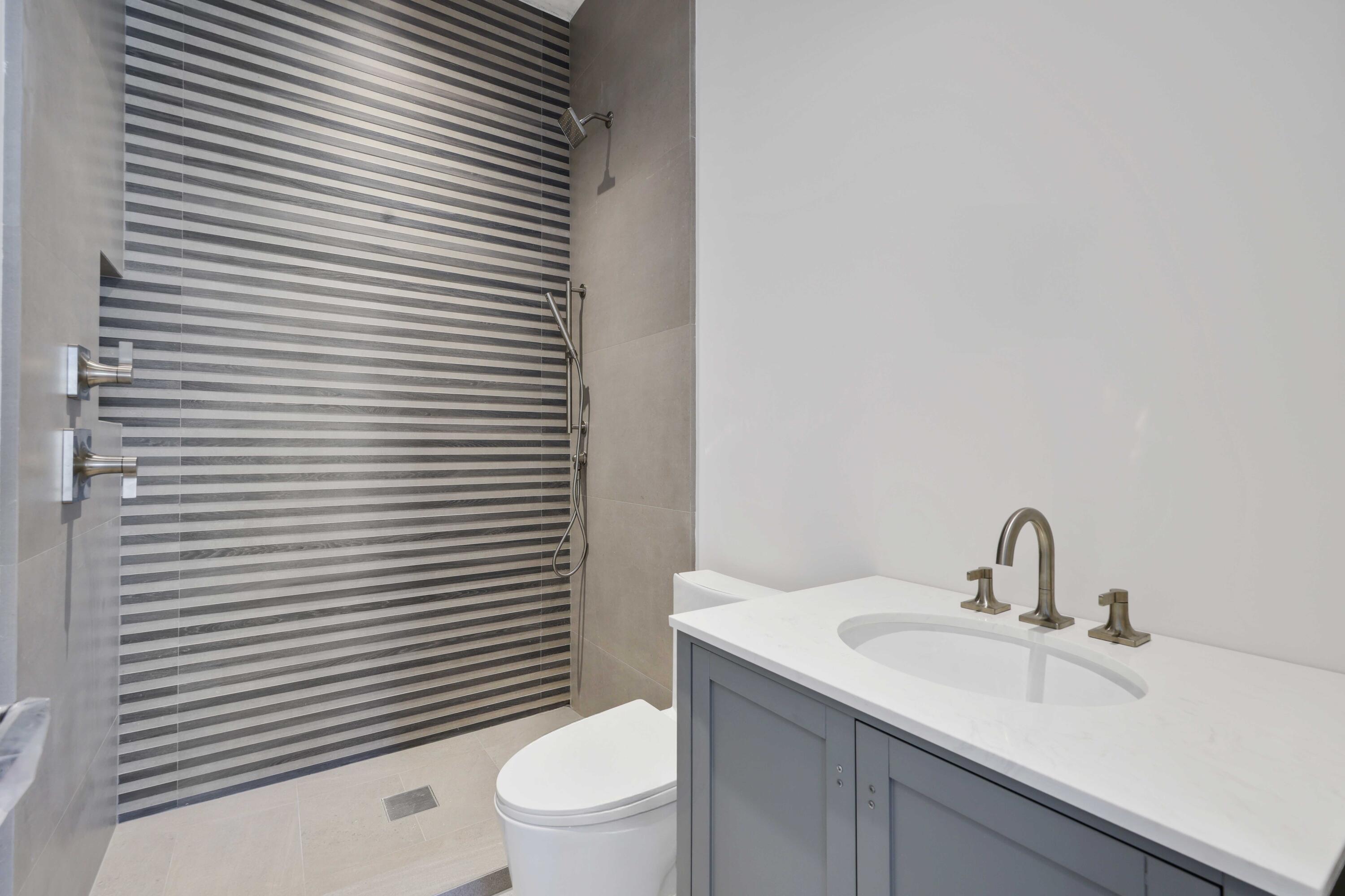 810 Northeast 70th Street Boca Raton, FL 33487 - Photo 32 of 32 a bathroom with a sink toilet and shower