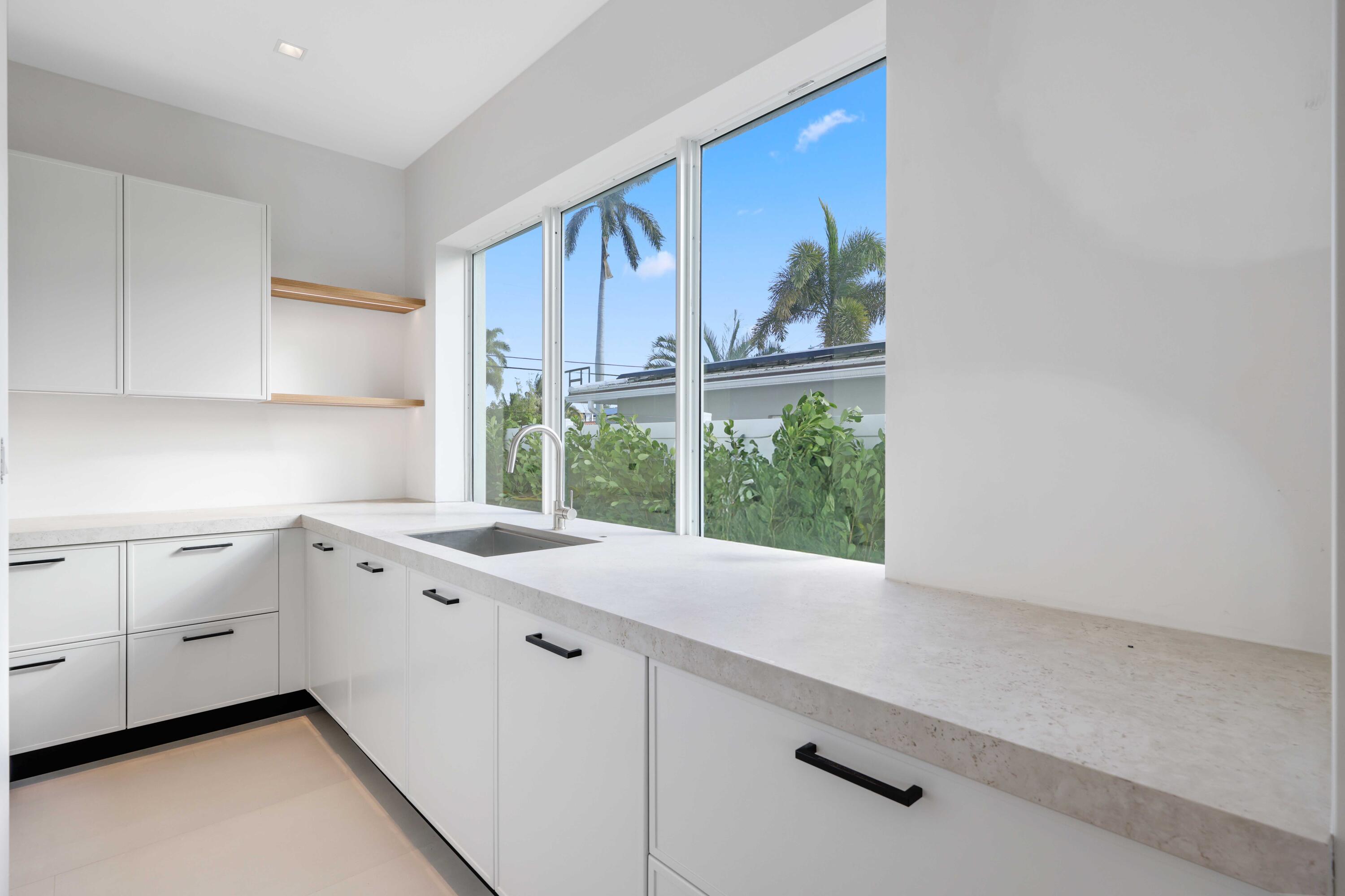 810 Northeast 70th Street Boca Raton, FL 33487 - Photo 9 of 32 a kitchen with a window a sink and a window