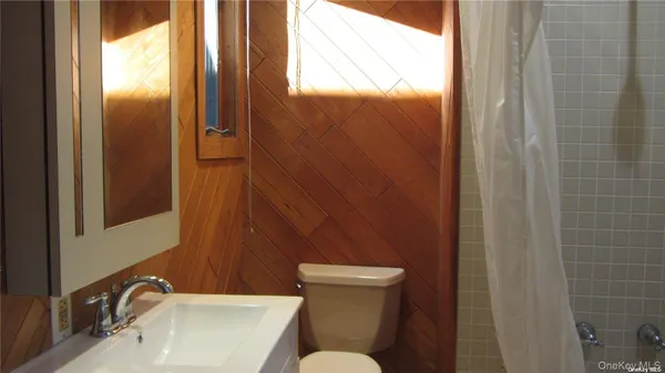 an empty room with wooden floor and a window