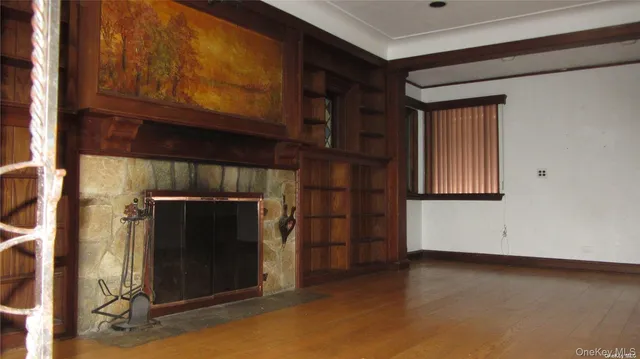 a view of an empty room and fire place