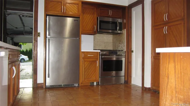 a kitchen with metallic refrigerator freezer and a dishwasher