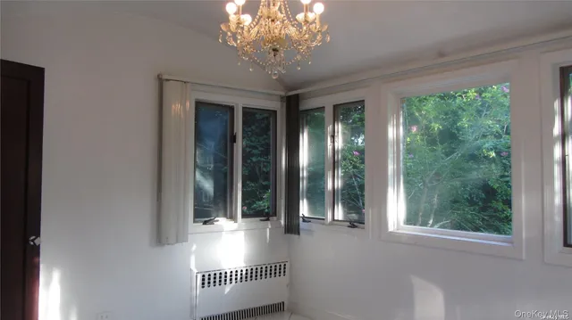 a view of a door with wooden floor and a window