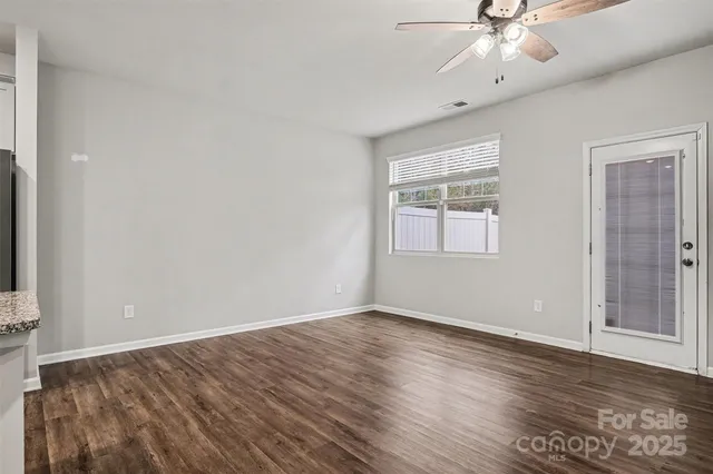 a large kitchen with stainless steel appliances granite countertop a stove a sink dishwasher and a white countertops with wooden floor