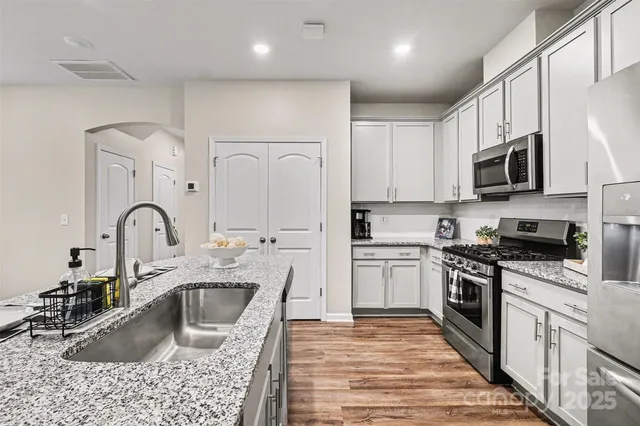 an empty room with a window and a ceiling fan