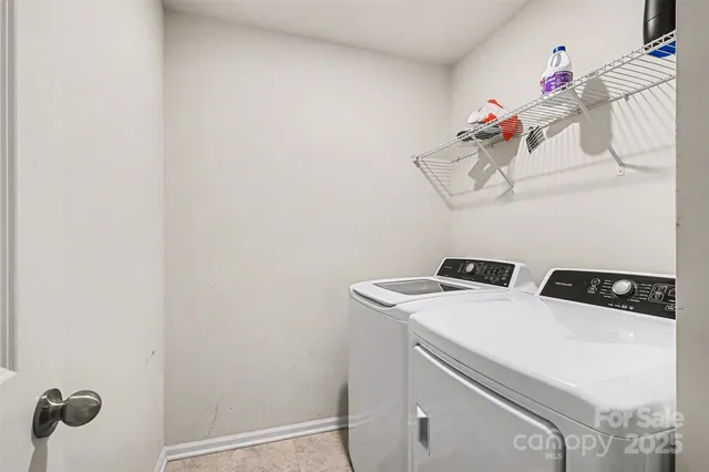 a kitchen with stainless steel appliances granite countertop a stove a refrigerator and a white cabinets