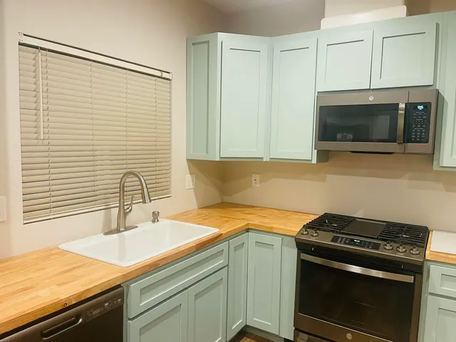 a kitchen with a sink and a stove top oven