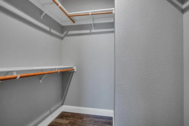 a view of storage and utility room with wooden floor