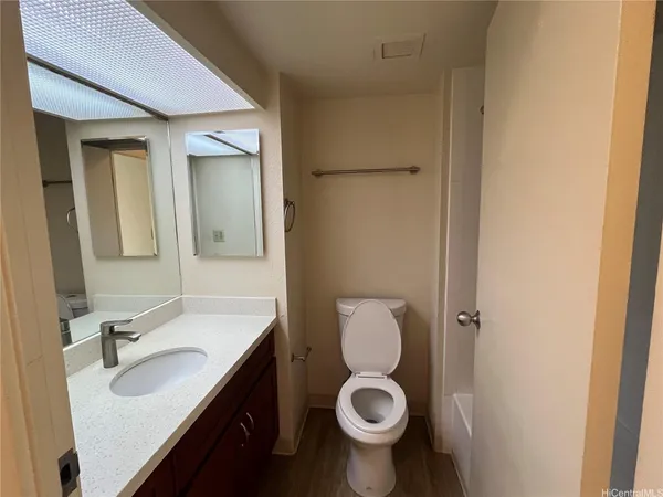 a bathroom with a sink toilet a mirror and vanity