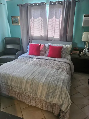 a bedroom with a bed and a couch