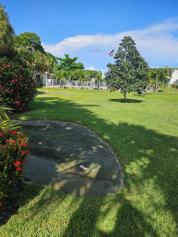 1045 Southeast 15th Street, Unit 13C Fort Lauderdale, FL 33316 - Photo 19 of 20 a view of a garden with a building in the background