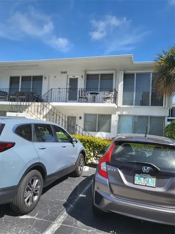 a front view of a house with parking area