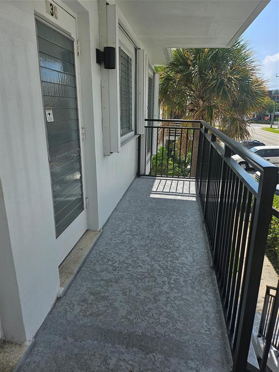 1045 Southeast 15th Street, Unit 13C Fort Lauderdale, FL 33316 - Photo 3 of 20 a view of a balcony with door and wooden floor